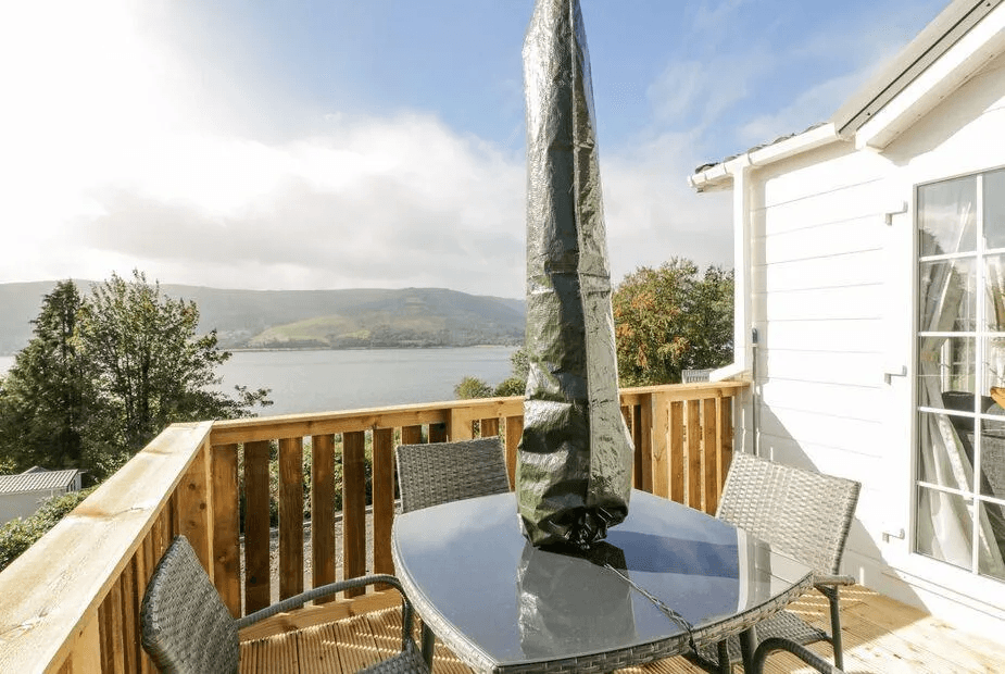 Private deck at 11 Mansion View with table and far-reaching Loch Long views