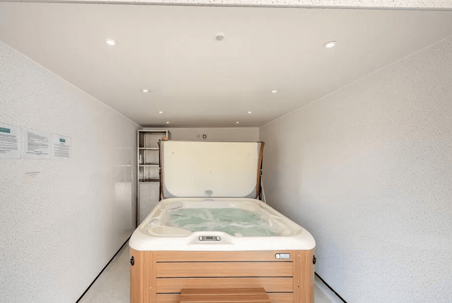 Private hot tub in covered timber-clad enclosure at Duck Bay Cottage 1